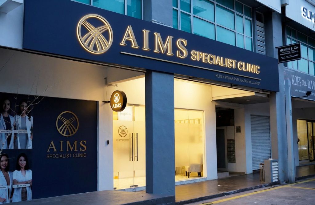 AIMS Specialist Clinic storefront on Ukay Boulevard: navy fascia with brass lettering above a glazed entrance